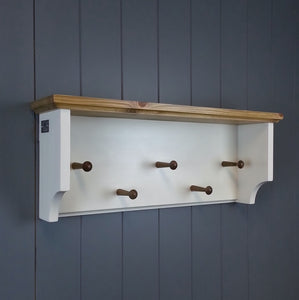 A white painted coat rack with an antique pine top and vintage coat pegs. Hang coats and hats neatly in your hallway.