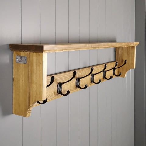 A compact coat rack for smaller hallways finished in antique pine