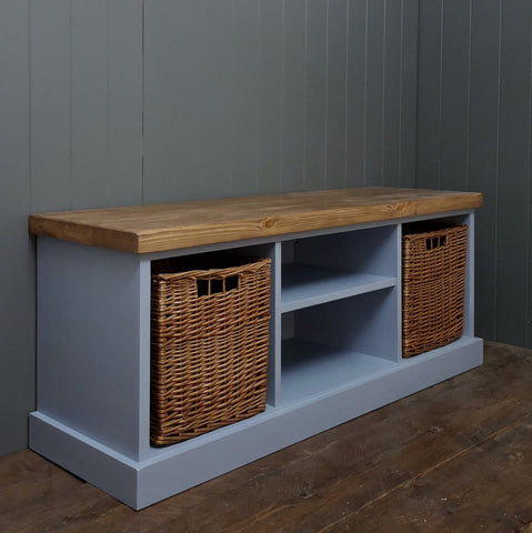 Blue painted hallway bench seat with two large baskets and two shelves to store shoes and trainers.