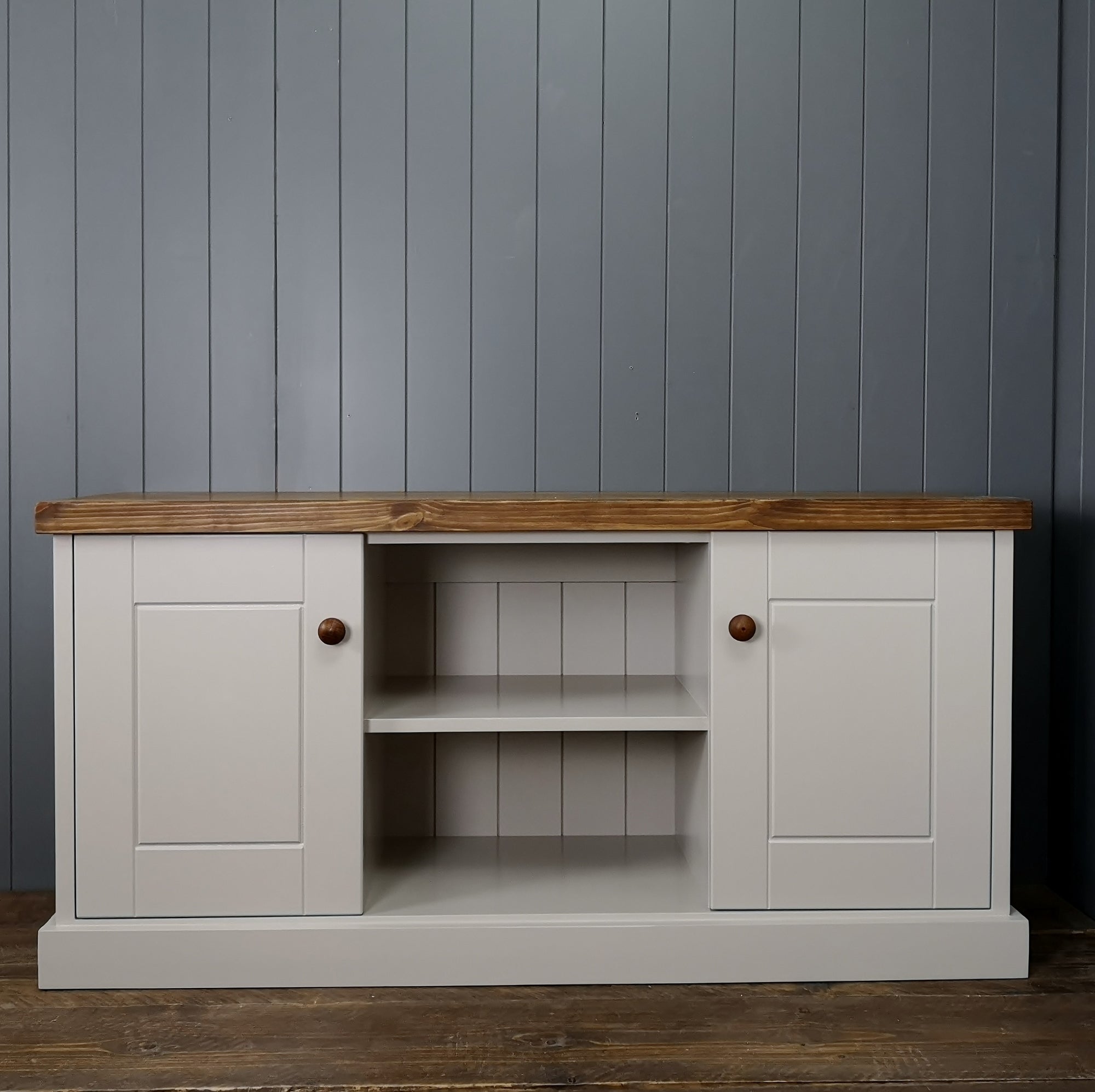 Cupboard can be used as a TV cabinet painted grey with antique pine top. 2 cupboard areas and a shelf in the middle.
