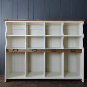 Hallway storage cabinet to organise shoes, boots, school bags & sports equipment.  A row of tall compartments with two shelves of compartments above. An antique pine strip with name plaques & antique pine top. Storage station is painted in antique white.