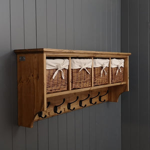An antique pine coat rack with wicker storage baskets