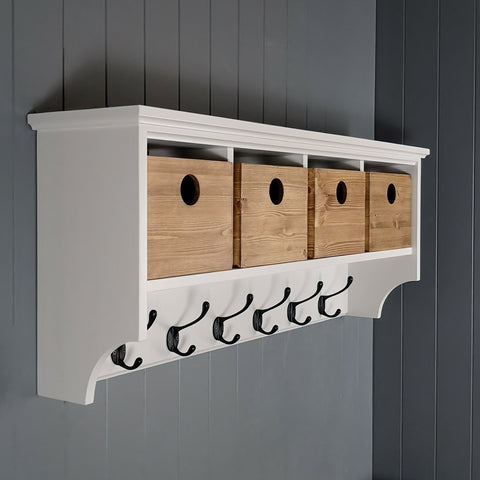 Coat rack for hallway or porch storage. Painted white with antique pine storage boxes and black hooks
