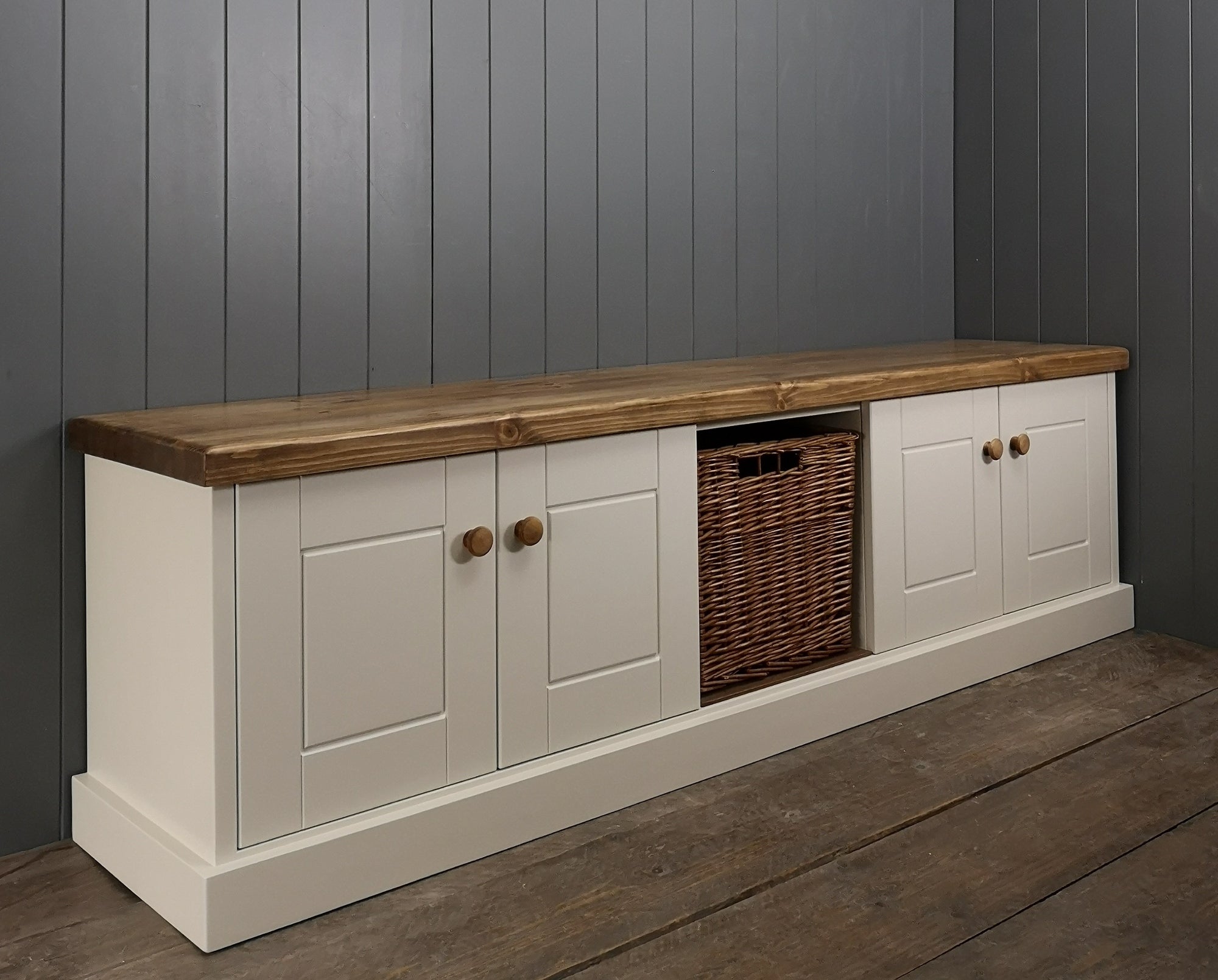 A painted cupboard wicker storage basket and second painted cupboard under an antique pine rustic top.