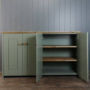 Dark Green painted storage cabinet. Door open to shoe two antique pine shelves