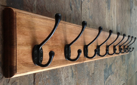 Hand made solid wood coat rack with black hooks finished in antique pine.