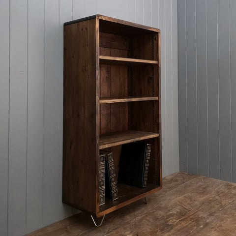 Large dark wood bookcase standing on hairpin feet. 4 adjustable shelves for books or display. Curved edges.