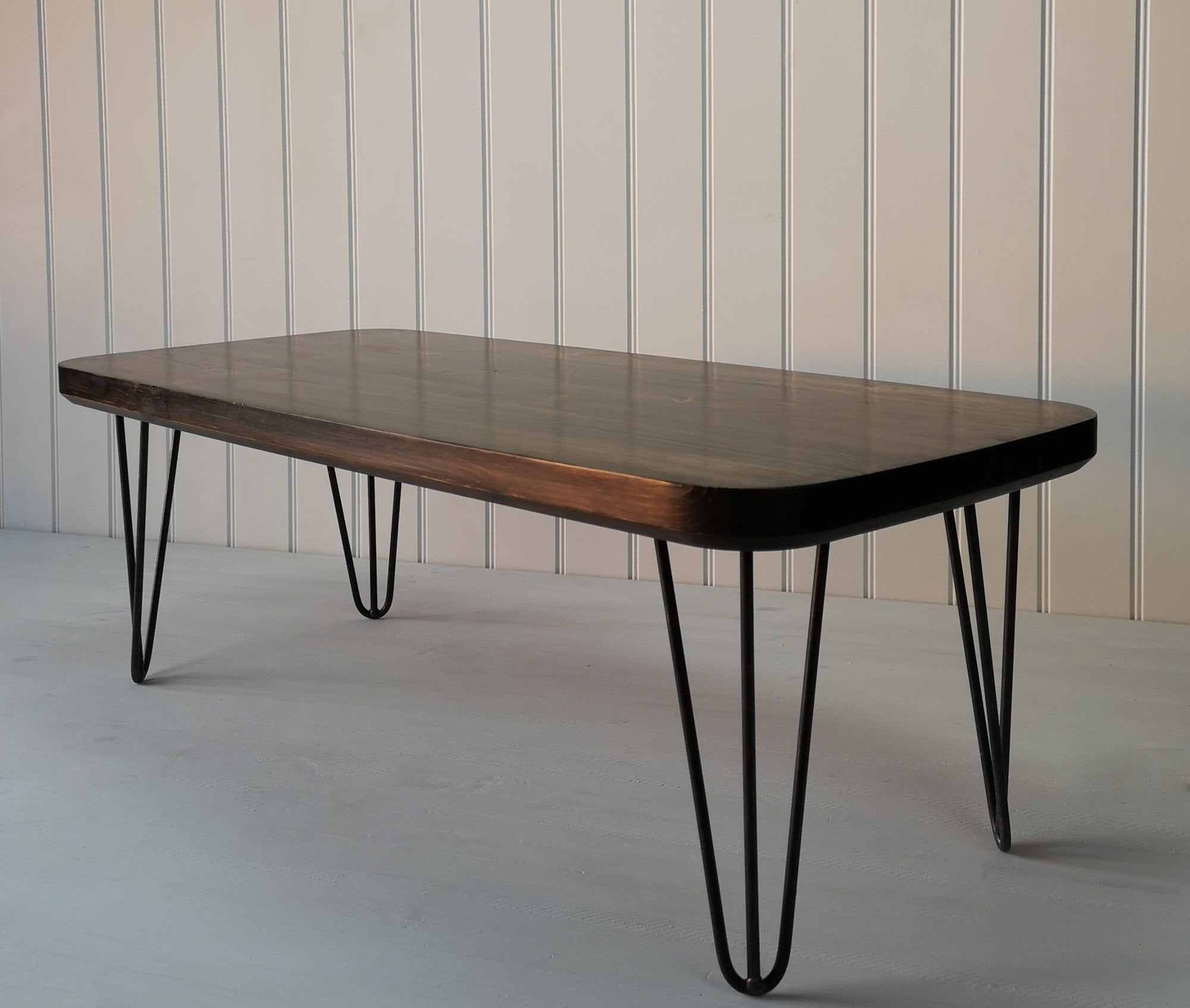 Dark wood finished  rectangular coffee table with curved edges and hair pin legs