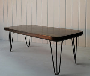 Dark wood finished  rectangular coffee table with curved edges and hair pin legs