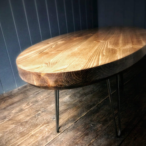Oval shaped antique pine coffee table on hairpin legs.